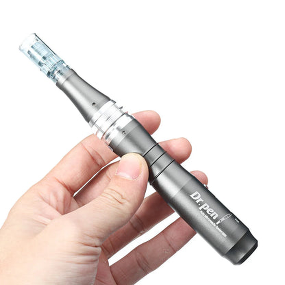 Dr. Pen M8 handpiece held in one hand to show its shape and size